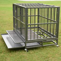 a metal cage sitting on top of a grass covered field