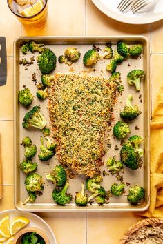 a pan filled with broccoli covered in seasoning on top of a table