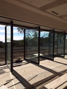 an empty room with glass walls in the middle