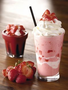 two drinks with strawberries on the table