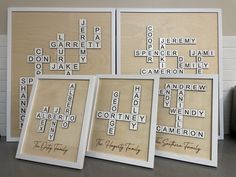 three framed scrabbles are sitting on a table