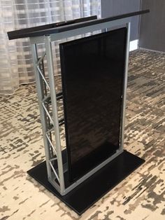 a black and silver stand on top of a carpeted floor