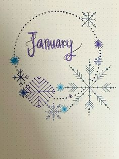 the word january written on a notebook with snowflakes and stars in front of it