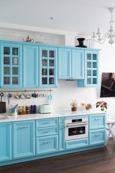 a kitchen with blue cabinets and white counter tops