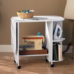 a white table with an ironing board and sewing machine on it's stand