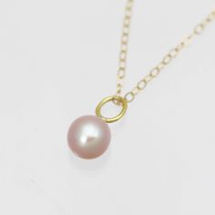 This is a handcrafted 14k yellow gold pearl pendant with a natural 7mm round AA grade cultured freshwater pink pearl. Comes on your choice of a 16 or an 18 inch 14ky gold cable chain. The artist's tag is attached at the clasp. Bail is 3.7mm inner diameter. Comes with a lifetime warranty, polishing cloth, care card, and a gift box. Available with a 5mm pearl: https://www.etsy.com/listing/927500998/pink-pearl-drop-necklace-in-14k-yellow?ref=shop_home_feat_4&frs=1 Available in rose gold: https: 14k Gold Necklace With Pearl Charm, 14k Gold Round Pearl Drop Necklace, Rose Gold Akoya Pearl Necklace Gift, 14k Gold Pearl Necklace With Round Pendant, Classic Pink Pearl Pendant Jewelry, Delicate Pink Pearl Necklace With Pendant, Delicate Pink Pearl Pendant Necklace, Rose Gold Necklaces With Pearl Charm, Rose Gold Round Necklaces With Pearl Charm