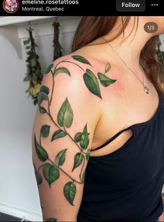 a woman with green leaves on her arm