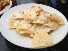 a white plate topped with nachos and chips