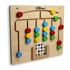 a wooden peg board with different colored knobs and numbers on the front, along with a matching toy