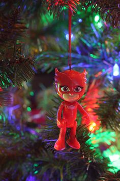 a red ornament hanging from a christmas tree