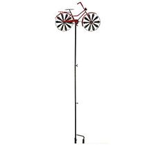 a metal pole with two windmills on it and a red bicycle mounted to the top