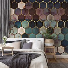 a bed sitting next to a wall covered in lots of hexagonal tiles on it