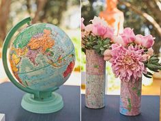 three vases with flowers in them sitting on a table next to an earth globe