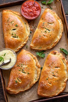 four pieces of bread on a tray with dipping sauce