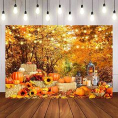 an autumn scene with pumpkins, hay bales and lights on the wall behind it