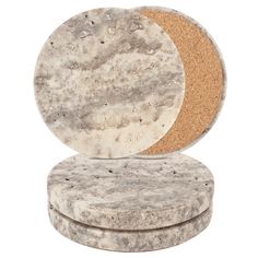 two round marble coasters sitting on top of each other, one with a cork lid