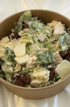 a salad in a bowl on a white table cloth