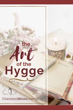 the art of the hygge book with a candle and flowers on it