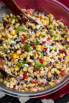 a bowl filled with corn, black beans and cheese