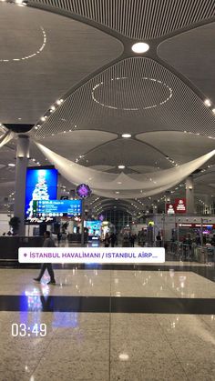 an airport terminal with people walking through it