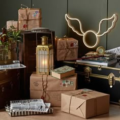 several pieces of luggage sitting on top of a wooden floor next to a light that is shaped like an angel