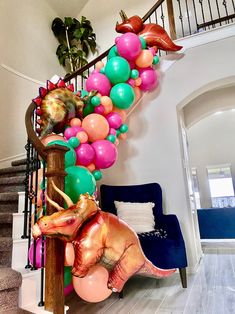 balloon garland on the stair railing with dinosaur balloons