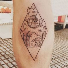 a tattoo on the leg of a person with mountains and trees in the background,