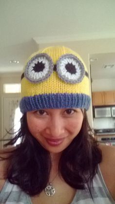 a woman wearing a knitted hat with eyeballs on it