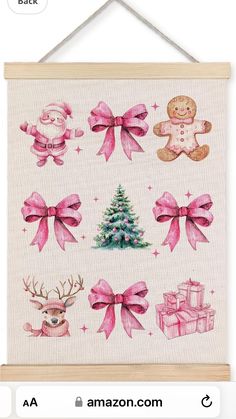 a cross stitch christmas card with pink bows and teddy bears on it, hanging from a wooden frame