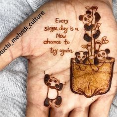 a person's hand with two pandas on it and the words every single day is a new chance to try again