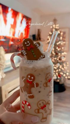 a person holding a drink with gingerbread cookies on it