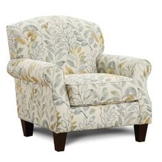 a chair that is upholstered with leaves on the back and arms, sitting in front of a white background