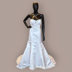 a mannequin dressed in a white wedding dress