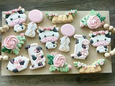 decorated cookies are arranged on a wooden board