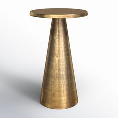 a gold colored table on a white background with no one around it to see the image