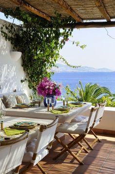 the table is set with white linens and place settings