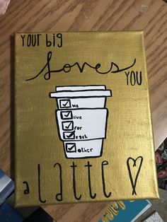 a coffee cup with the words you're big loves you written on it is sitting on a table