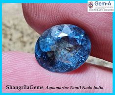 a blue diamond is being held in someone's hand with the caption shargila gems aquamarine tanti nadda india