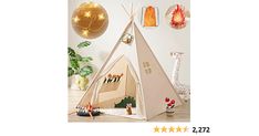 a child's teepee tent with lights on the wall