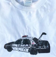 a white shirt with a police car on it