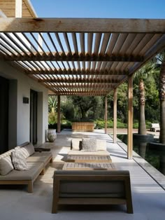 an outdoor covered patio with couches and tables