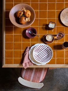 an overhead view of a table with plates, cups and bowls on the table top