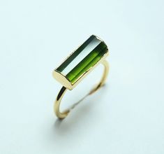 This Listing is for 1 Piece Of 14K GoldFill Ring, Made With Creative Art. The Ring Is Made With Genuine Gemstone & 14K GoldFill Material. Product Details : Gemstone : Natural Green Tourmaline Gemstone Quality : AAA+ Metal : Copper & Gold (14K GoldFill) Stone Size : 15-13 MM APPROXIMATELY. You Will Receive Beautiful Ring, A Perfect & Unique Ring Gift for your Loved ones. Thank you for choosing Jewels Creation. Have a great day :-) Stacked Engagement Ring, Green Tourmaline Crystal, Black Tourmaline Ring, Raw Tourmaline, Raw Stone Ring, Gold Filled Ring, Ring Stacking, Tourmaline Ring, Raw Stone