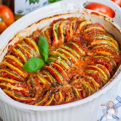 a casserole dish filled with vegetables and sauce