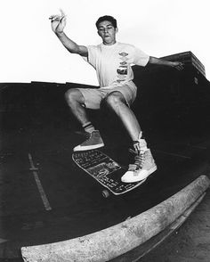 a man riding a skateboard up the side of a ramp