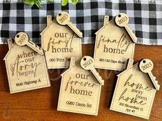 four wooden house shaped tags with names on them