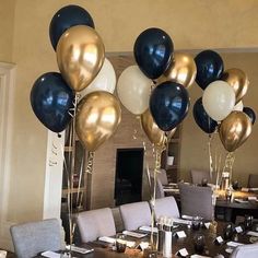 the table is set with black and white balloons