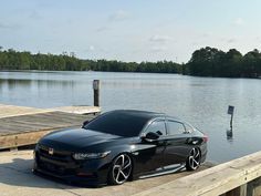 a black car is parked on the dock