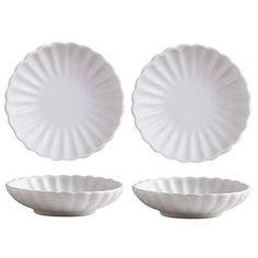 three white plates sitting next to each other