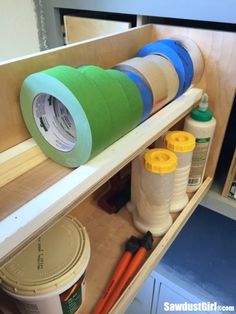 the shelves are filled with different types of crafting supplies, including plastic cups and spools